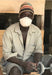 Ugandan cow horn artisan sitting at his workbench 