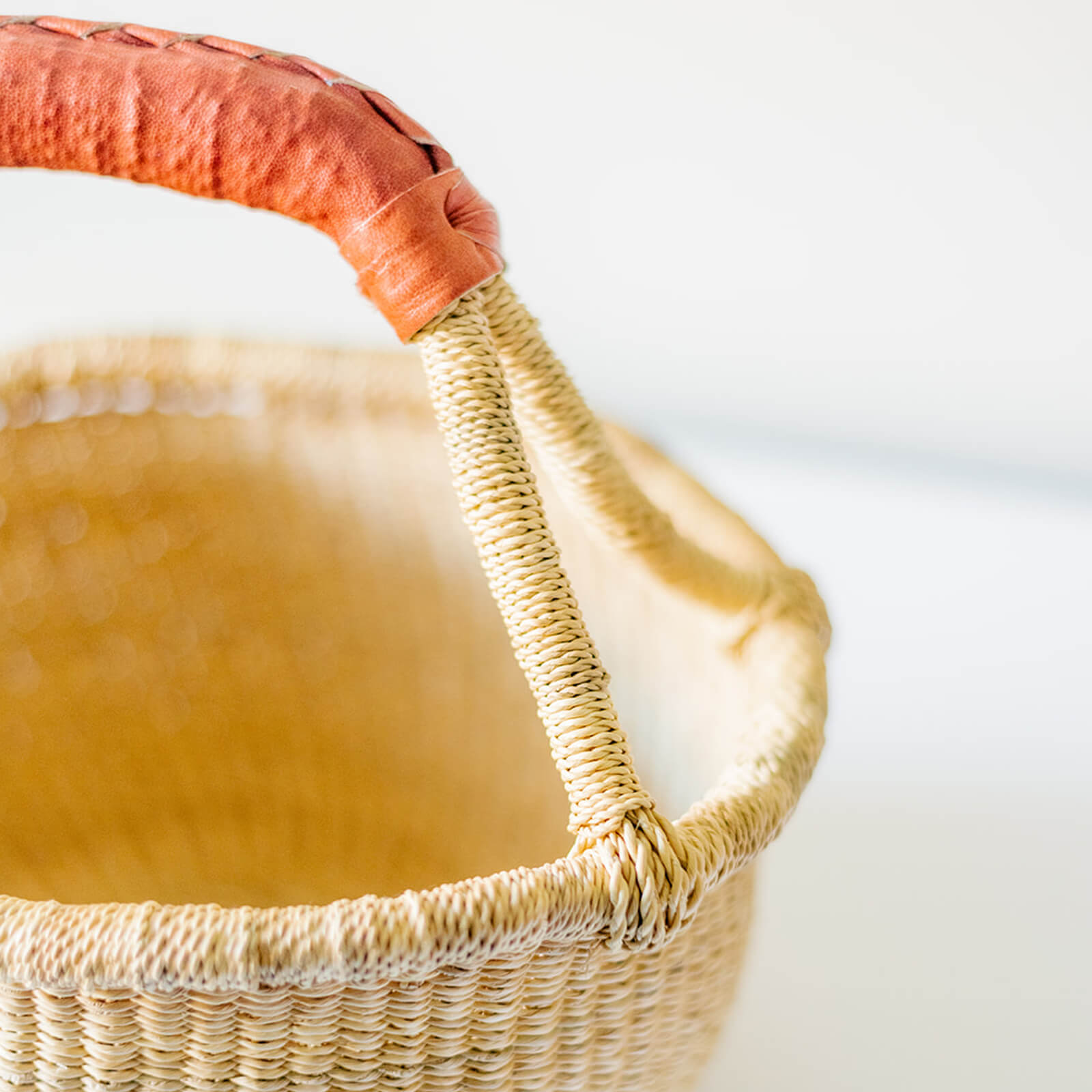 Closeup of the handles and leather wrapping on an extra small bolga basket 