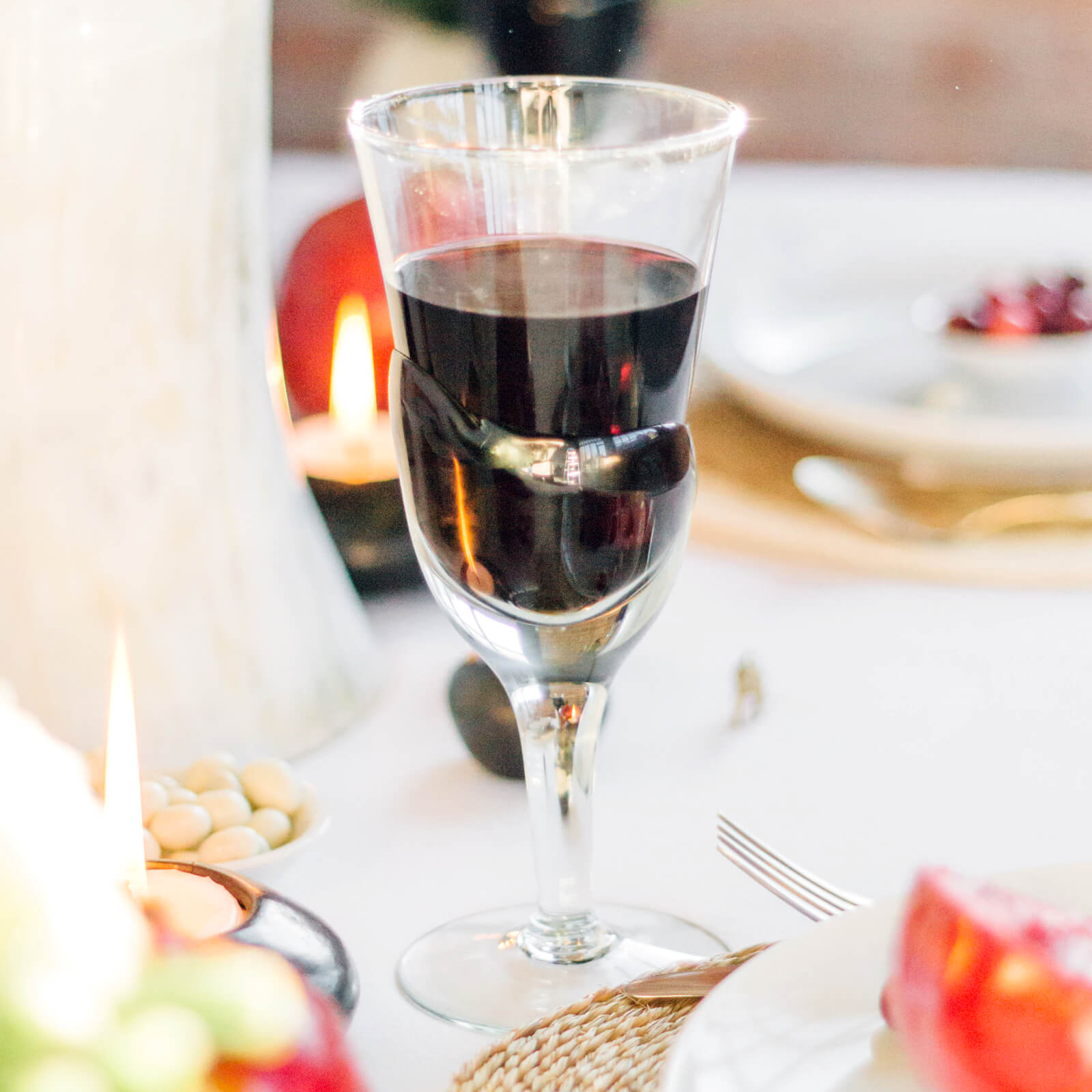 handmade red wine goblets on a holiday table
