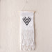 Black and white beaded wall hanging made by Tanzanian Maasai artisans  with three v shapes 