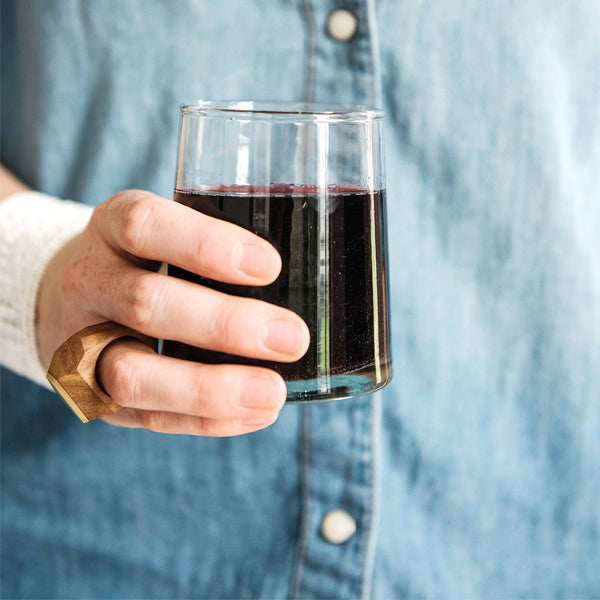 Woman holding a 6 ounce Moroccan glass drinking glass filled with wine 