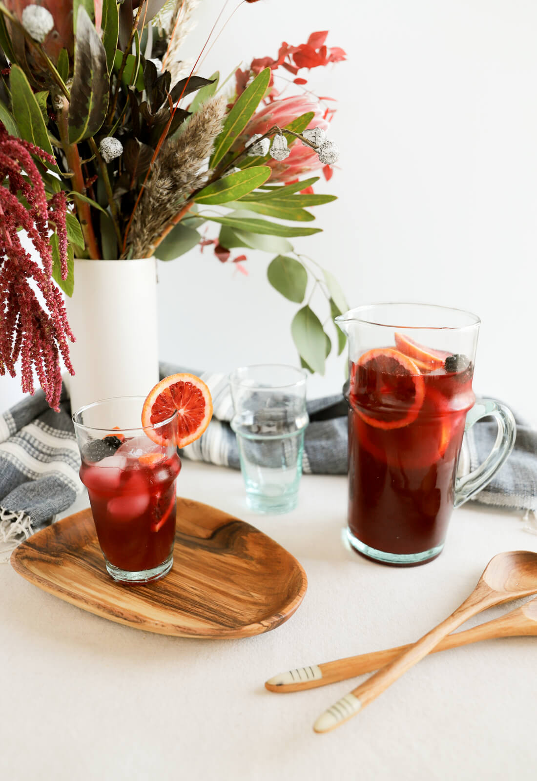 Dining room table scene set with a pitcher of sangria and recycled Moroccan glassware.