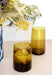 Amber brown tinted Moroccan recycled drinking glasses, styled on a dining room table 