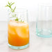 Moroccan recycled drinking glasses, shown with juice and ice. 